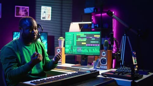 Musician Producing Music in a Purple Tone Studio