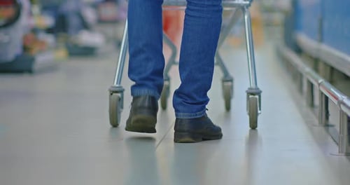 Shopping in Supermarket Man with Cart Walking in Aisles Closeup View of Feet on Floor Prores
