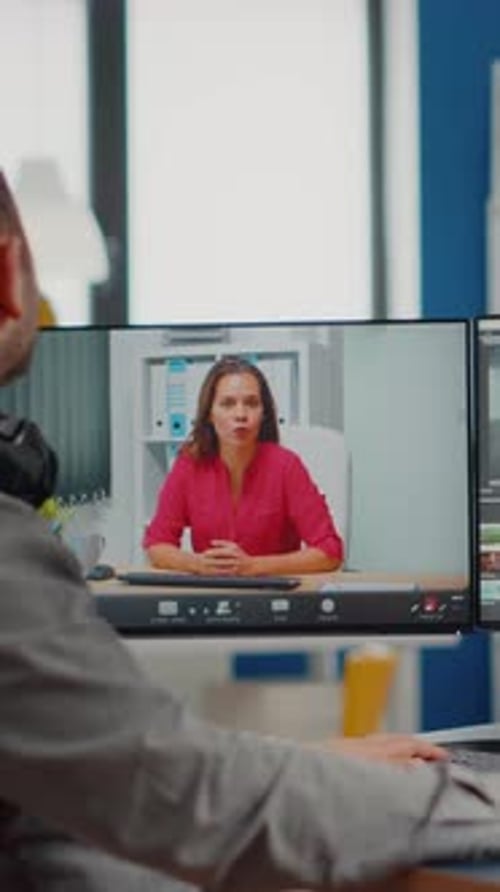 Man Attends Virtual Meeting on Computer Screen