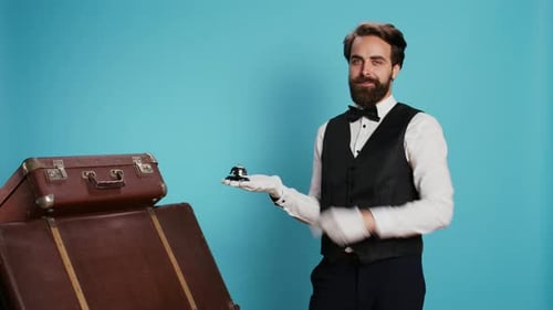 Man in Suit Points at Hotel Bell