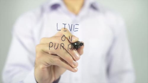 Hand Writes "Live on Purpose" Message