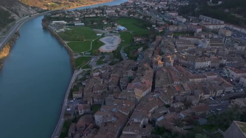 Stone fortress overlooks valley and rooftops in Provence