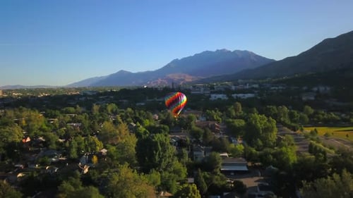 Colorful Hot Air Balloon Soars Above Suburbia