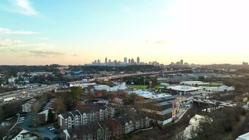 Distant View Of Atlanta City Skyline With Traffic Jam On Bustling Highways And Roads. aerial shot