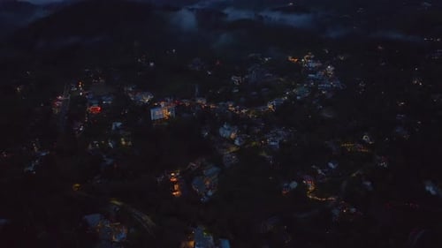 Aerial Descending Footage of Remote Town in Landscape High Angle View of Lighted Separate Buildings