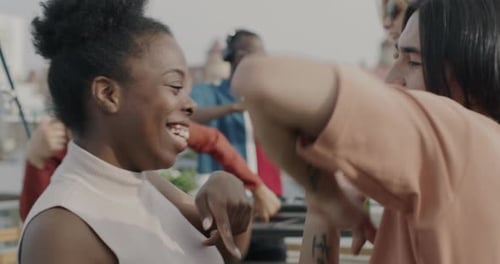 Friends Dancing at an Energetic Rooftop Party