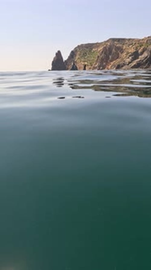 Vertical Close Up View on Sea Water Surface Camera Flies Over Clear Sea Water Sun Glare Abstract
