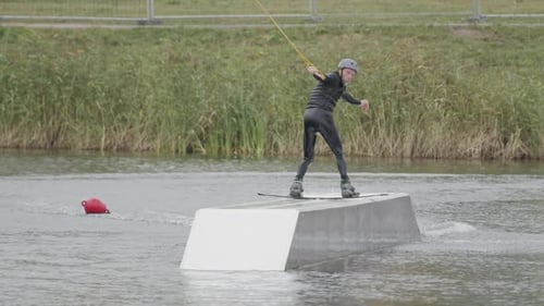 Wakeboarder Back Sliding in Wake Park
