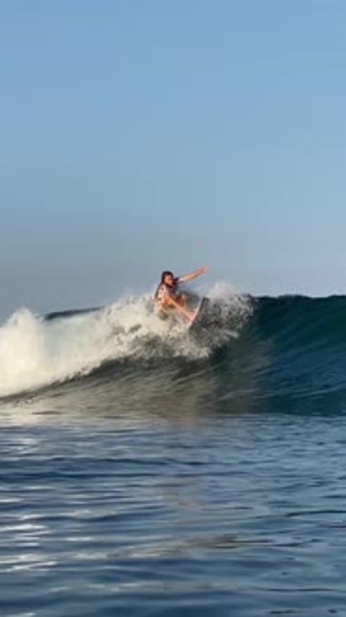 Young Guy Surfs in the Ocean