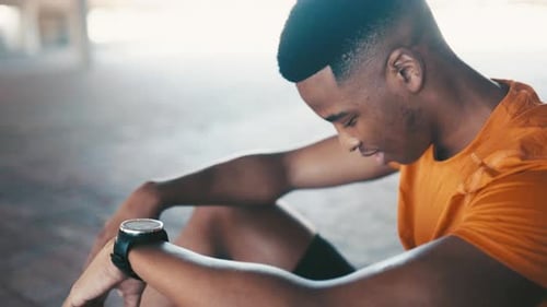 Man Checks Smartwatch After Workout