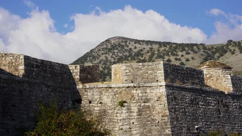 Medieval castle stone walls of fortress with mountain background in Mediterranean