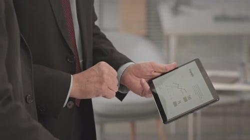 Colleagues Discussing Business Presentation on Digital Tablet