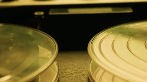 Vintage Audio Tape Recorder Reels Spinning in Warm Light Close Up