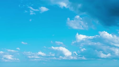 Clouds Moving Slowly Across a Bright Blue Sky