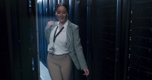 Woman Dances Happily in Dark Server Room