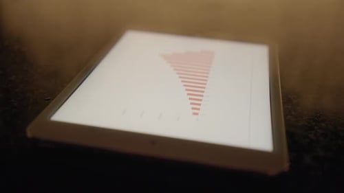 Tablet Displays Charts and Graphs on Dark Surface