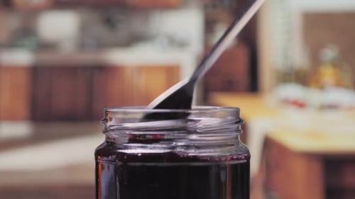 Spoon Retrieves Delicious Jam in the Kitchen
