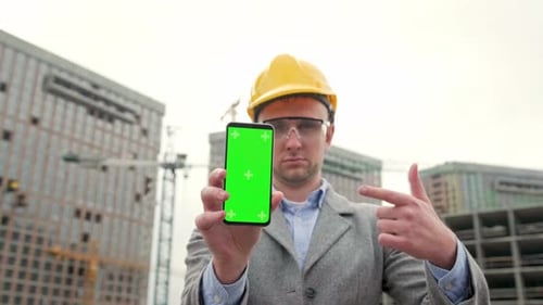 Site Supervisor is Posing for Camera Against Unfinished New Building