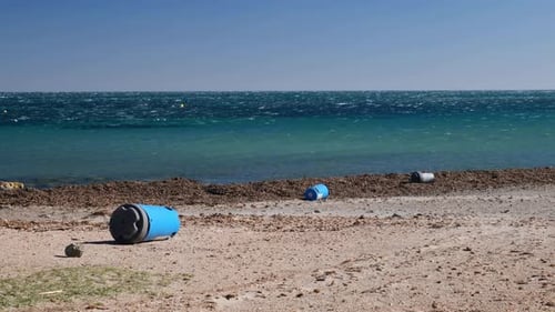 The storm has knocked over the trash cans on the beach