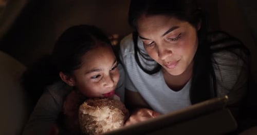 Mother, child and tablet at night in dark for online entertainment or streaming cartoons