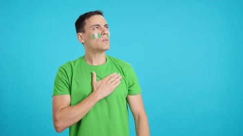 Man Listening to the Nigeria National Anthem with Solemnity