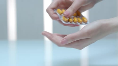 Woman hand taking prescription pills dose for healthcare treatment and therapy