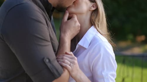 Romantic Couple Kissing in an Embrace Outdoors