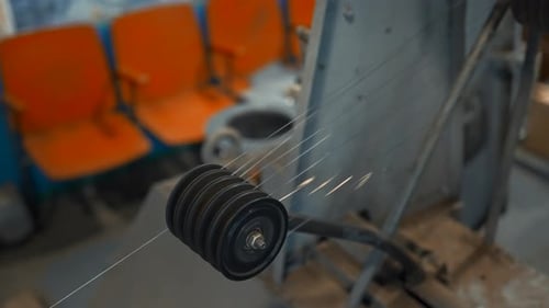 Metal threads rotate on industrial machine. Creative. Rotating shafts with metal thread