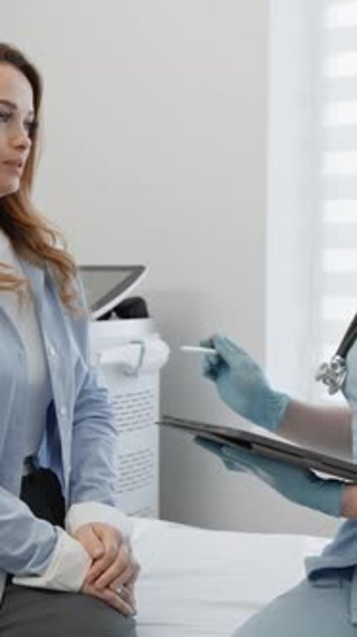 Woman Consults with Doctor in Bright Medical Office