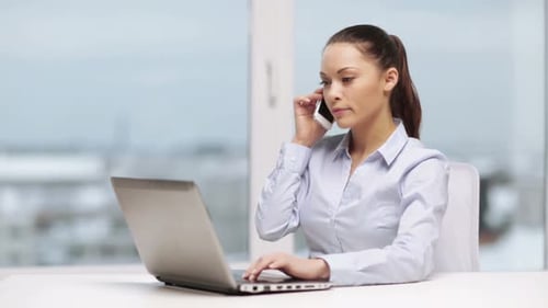 Serious businesswoman using smartphone in modern office workplace technology