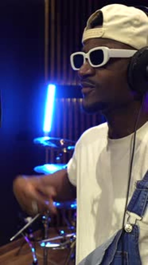 Young african american artist recording music in studio
