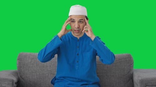 Sick Muslim man suffering Headache Green screen