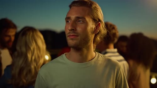 Smiling Man in Group at Outdoor Party Night