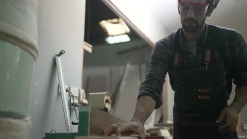 Carpenter is working at workshop.