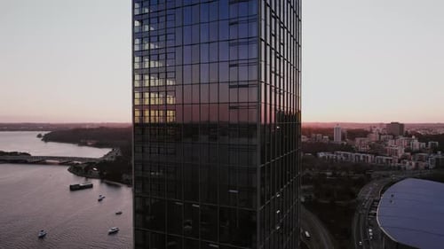 Spectacular sunset view over modern urban skyline reflecting off tall building