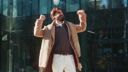 Excited Man Looking Surprised Clenching Fists Shocked By Sudden Victory Standing on City Street