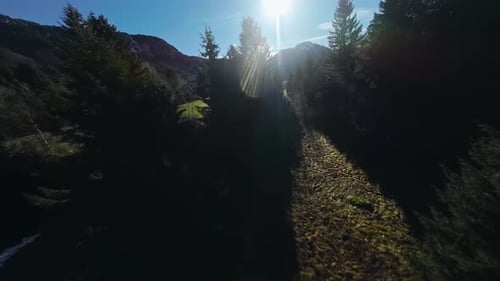 Aerial view of a mountain behind a mountain forest