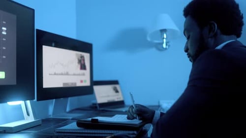 Business African trader investor making stock market analysis video call inside office at night