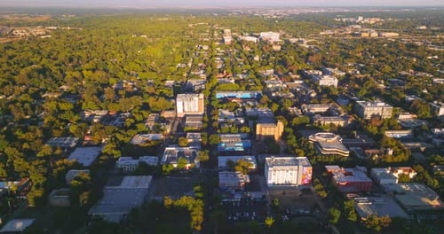 Vast urban panorama with lots of greenery on sunny daytime. Dense architecture of the city