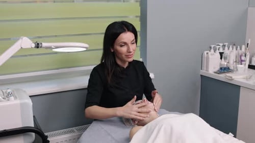 Woman Receiving Facial Massage in Clinic