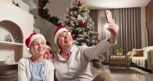 Grandmother and Granddaughters Taking Christmas Selfie