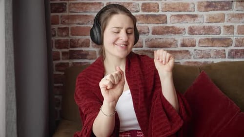 Enthusiastic Woman Listening to Music and Singing