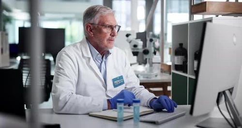 Mature Scientist Working in Modern Laboratory