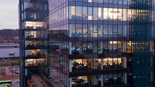 Cinematic Night View of Glass Skyscrapers with LateNight Office Workers