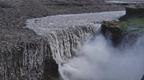 Dettifoss Waterfall Cascading Into Mist Filled Gorge in Iceland