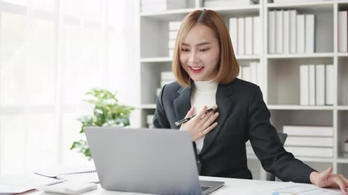 Young Woman Working at Laptop and Making Video Call
