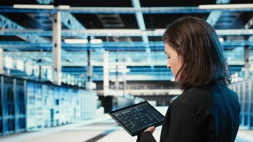 Data Center Programmer Coding on Tablet Optimizing Equipment Rigs