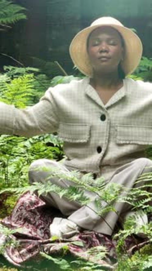 Woman Meditating in a Fern Forest