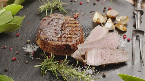 Grilled Steak Garnished with Rosemary and Garlic