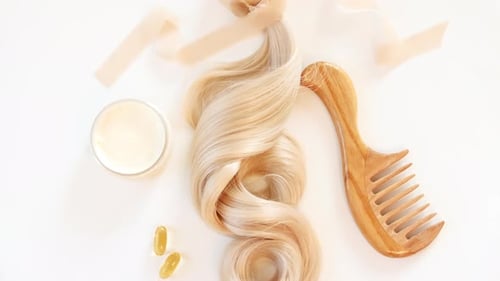 Blond Shiny Wavy Hair on White Background Shiny Woman Hair Strand Curl Hair Care and Beauty Salon